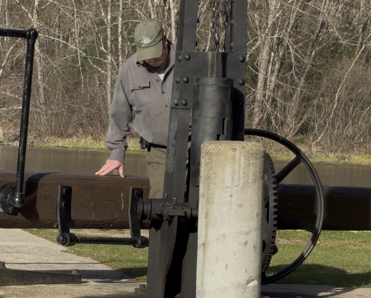 Songo Lock tender operating the historic lock mechanism in Naples Maine