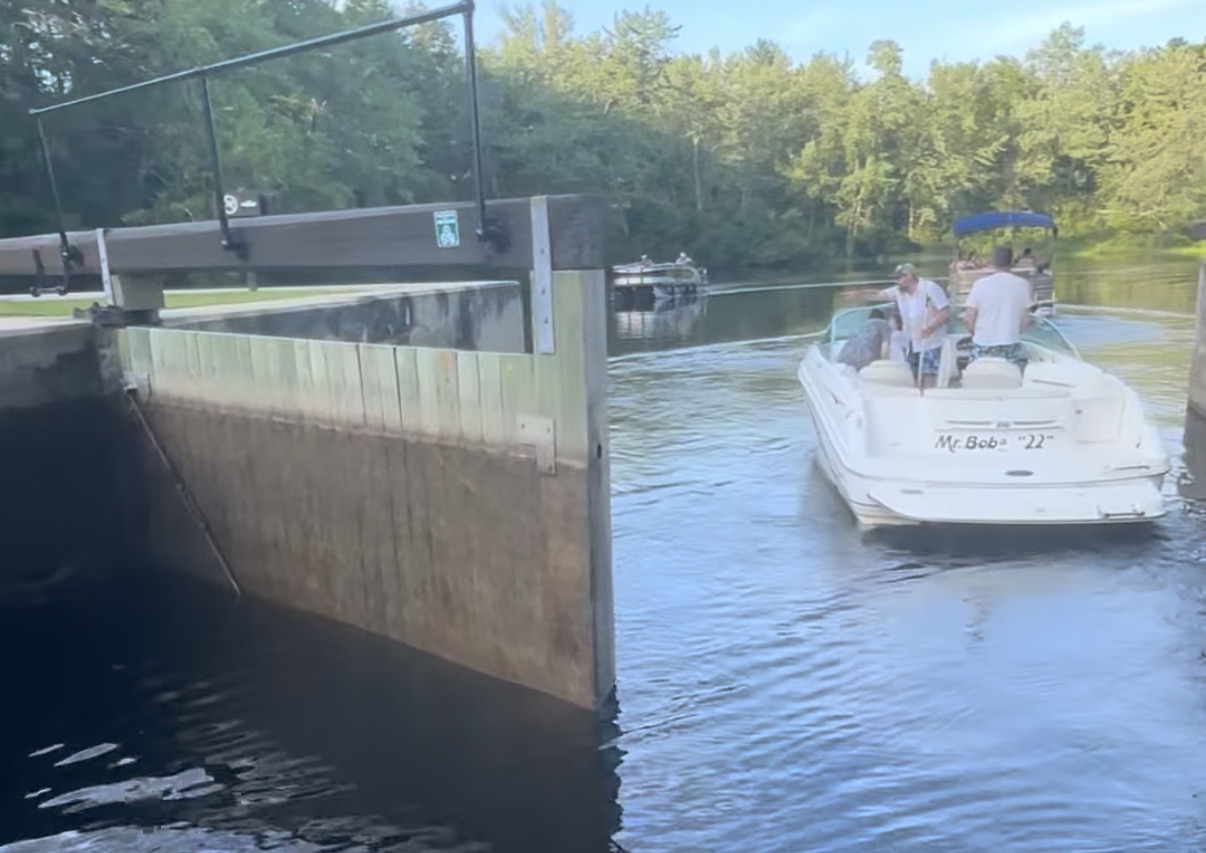 Boat entering Songo Lock near Naples Maine on a summer evening