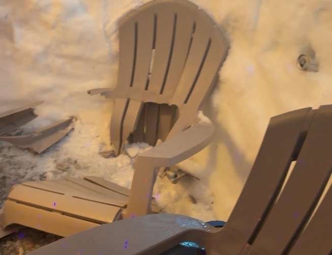 Cracked plastic Adirondack chair broken inside an igloo