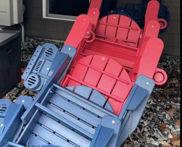 Folded and stacked composite Adirondack chairs ready for storage