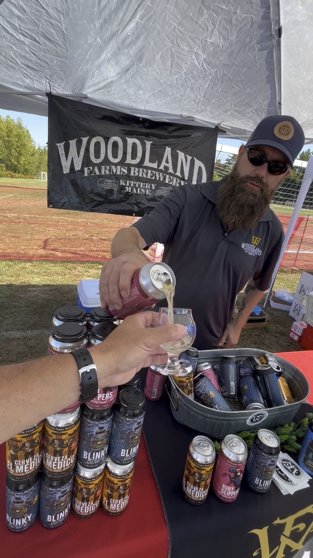 Brewers pouring beer at the Maine Lakes Brewfest in Bridgton