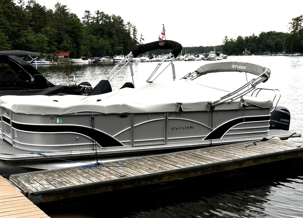 Pontoon boat in a properly sized slip at a Sebago Lake marina