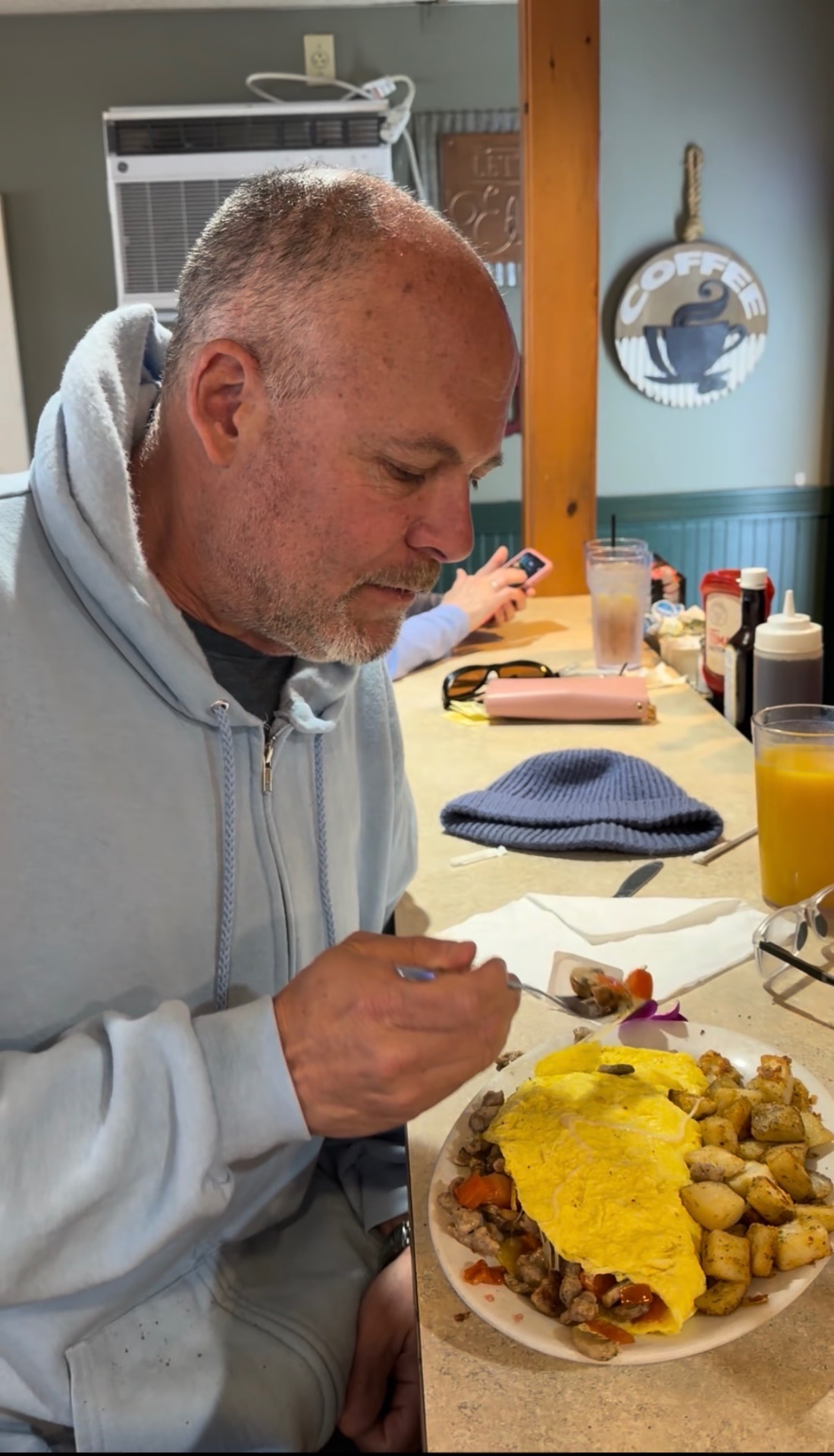 Diner enjoying a large omelet at the counter at Kelley's Sebago Diner