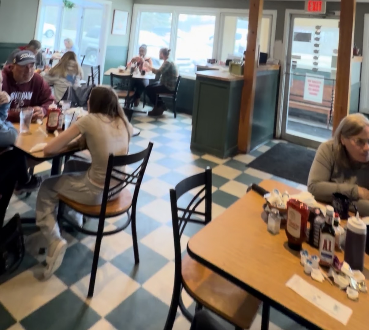 Inside Kelley's Sebago Diner with checkerboard floor and locals enjoying breakfast